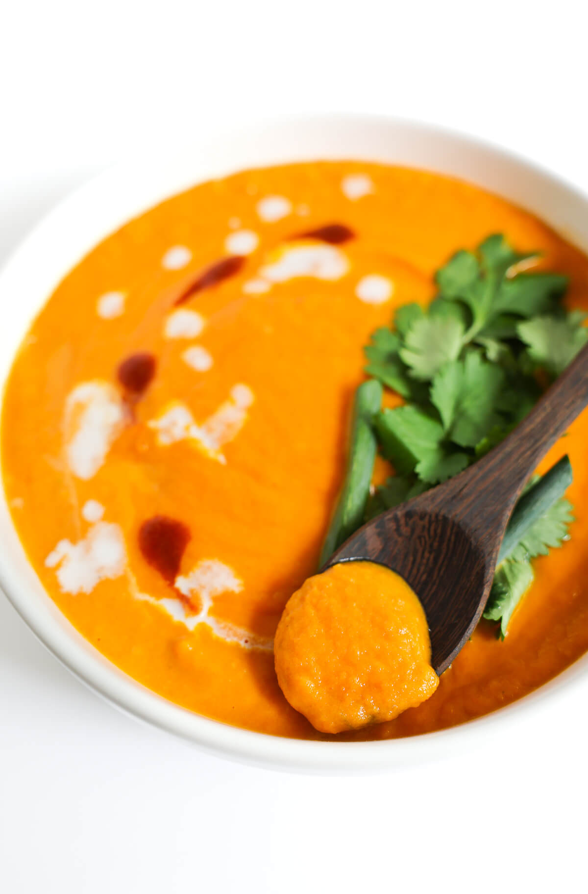 close up spoonful of thai carrot soup.