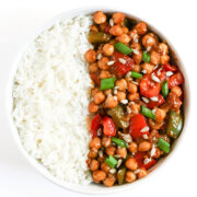 overhead view of finished bowl of kung pao chickpeas with white rice.
