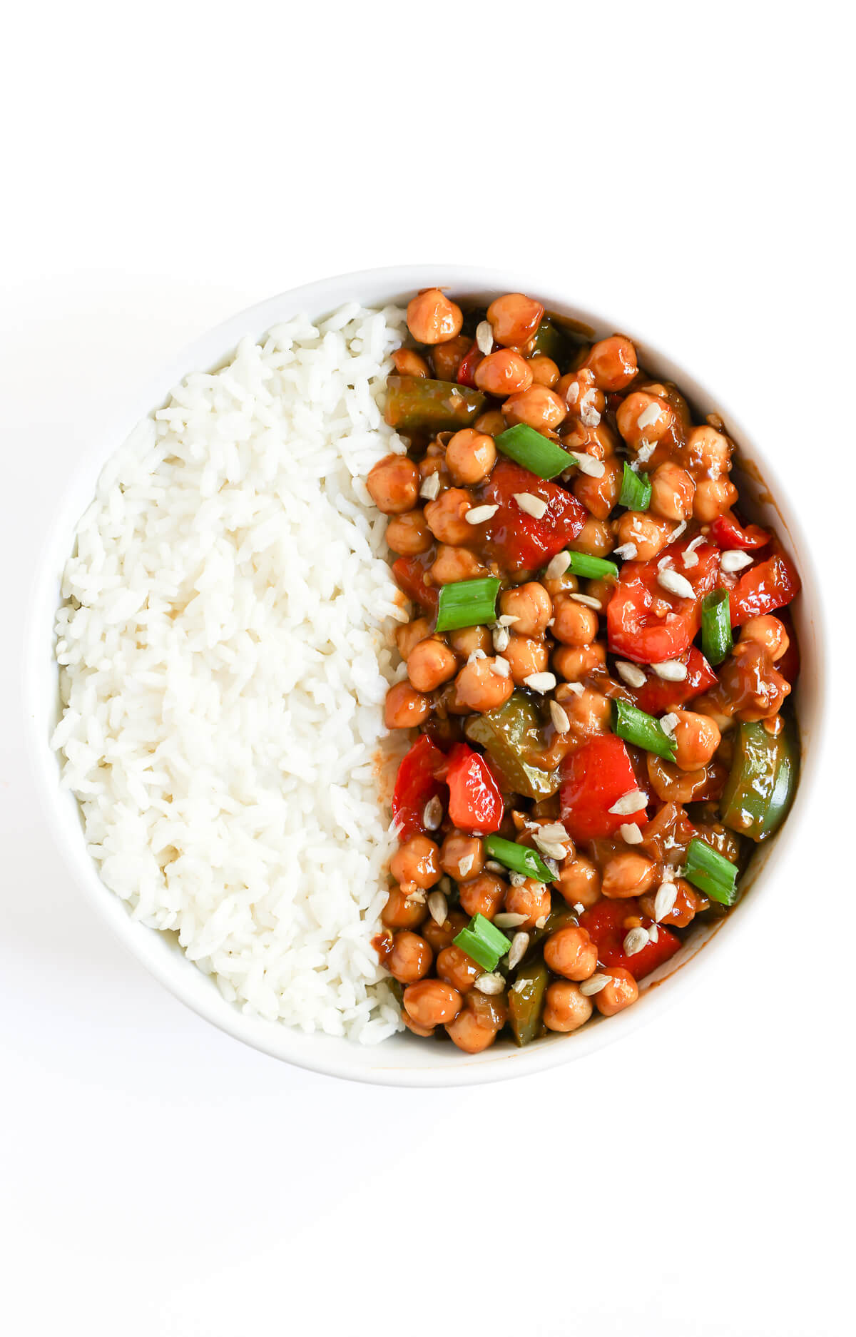 overhead view of finished bowl of kung pao chickpeas with white rice.