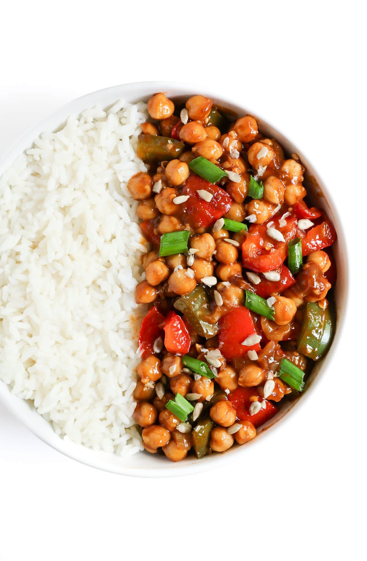overhead view of kung pao chickpeas with sunflower seeds and green onion.