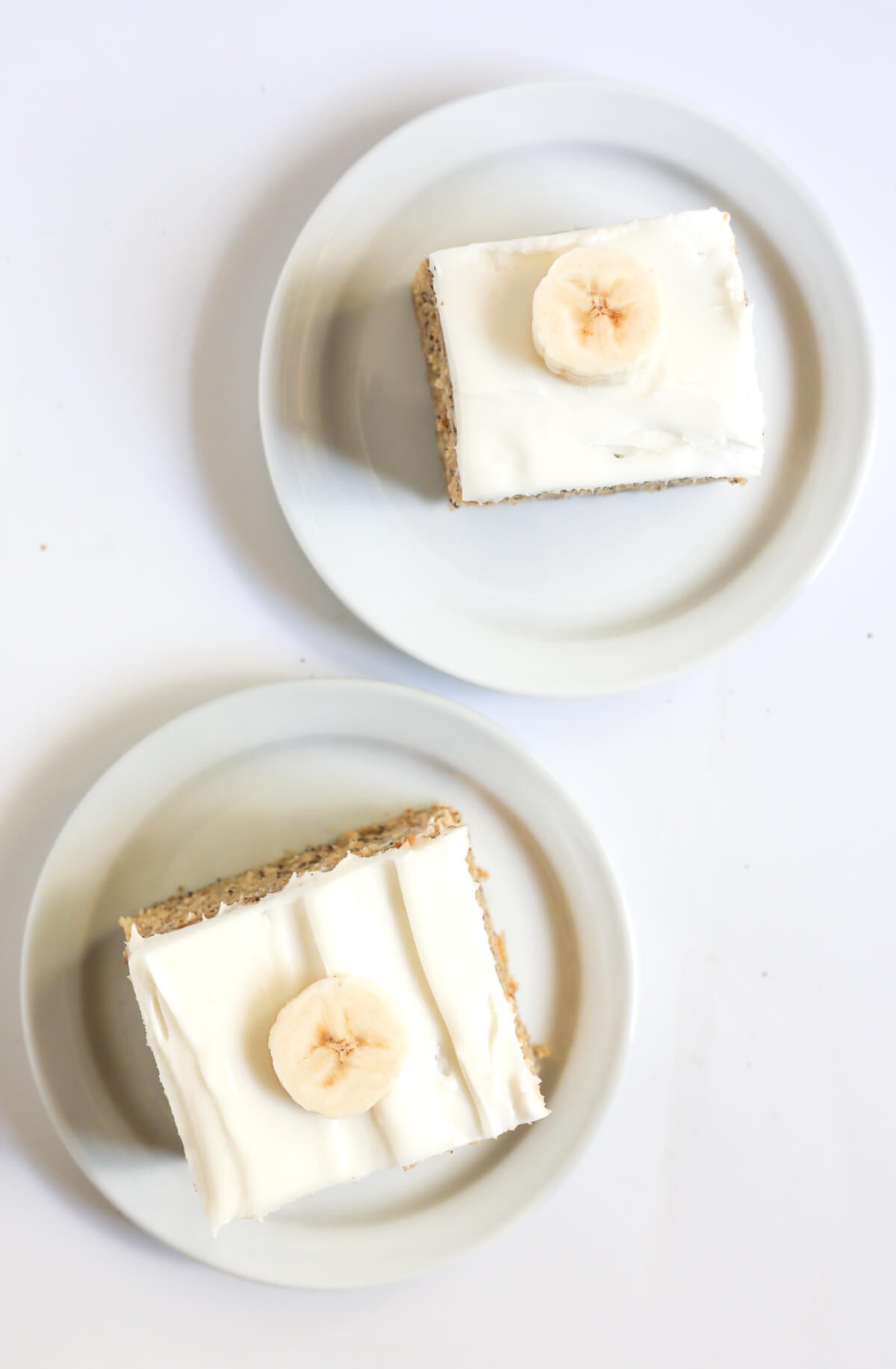 two slices of gluten-free and vegan banana cake on plates.