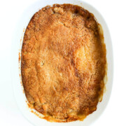 full casserole dish with peach dump cake.