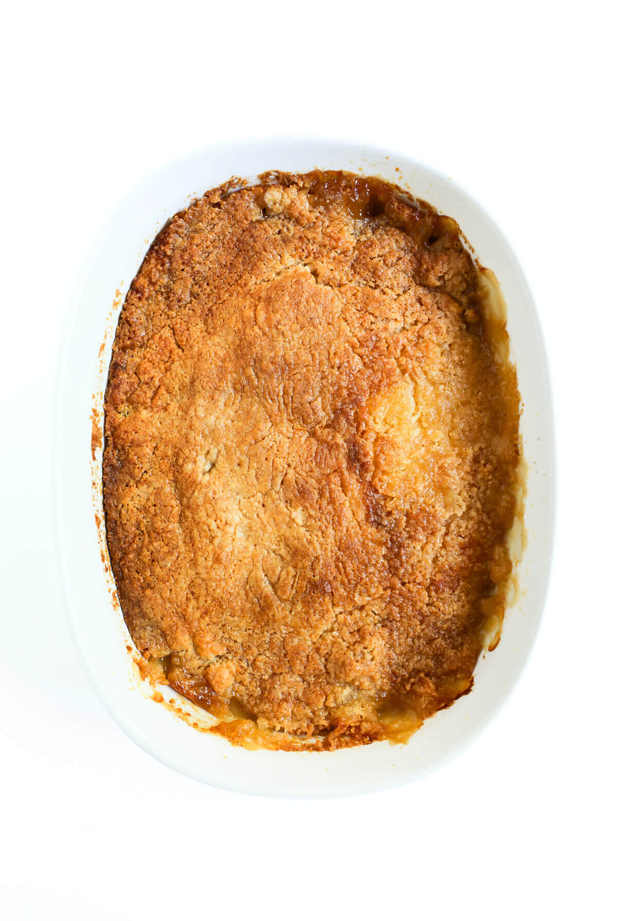 full casserole dish with peach dump cake.